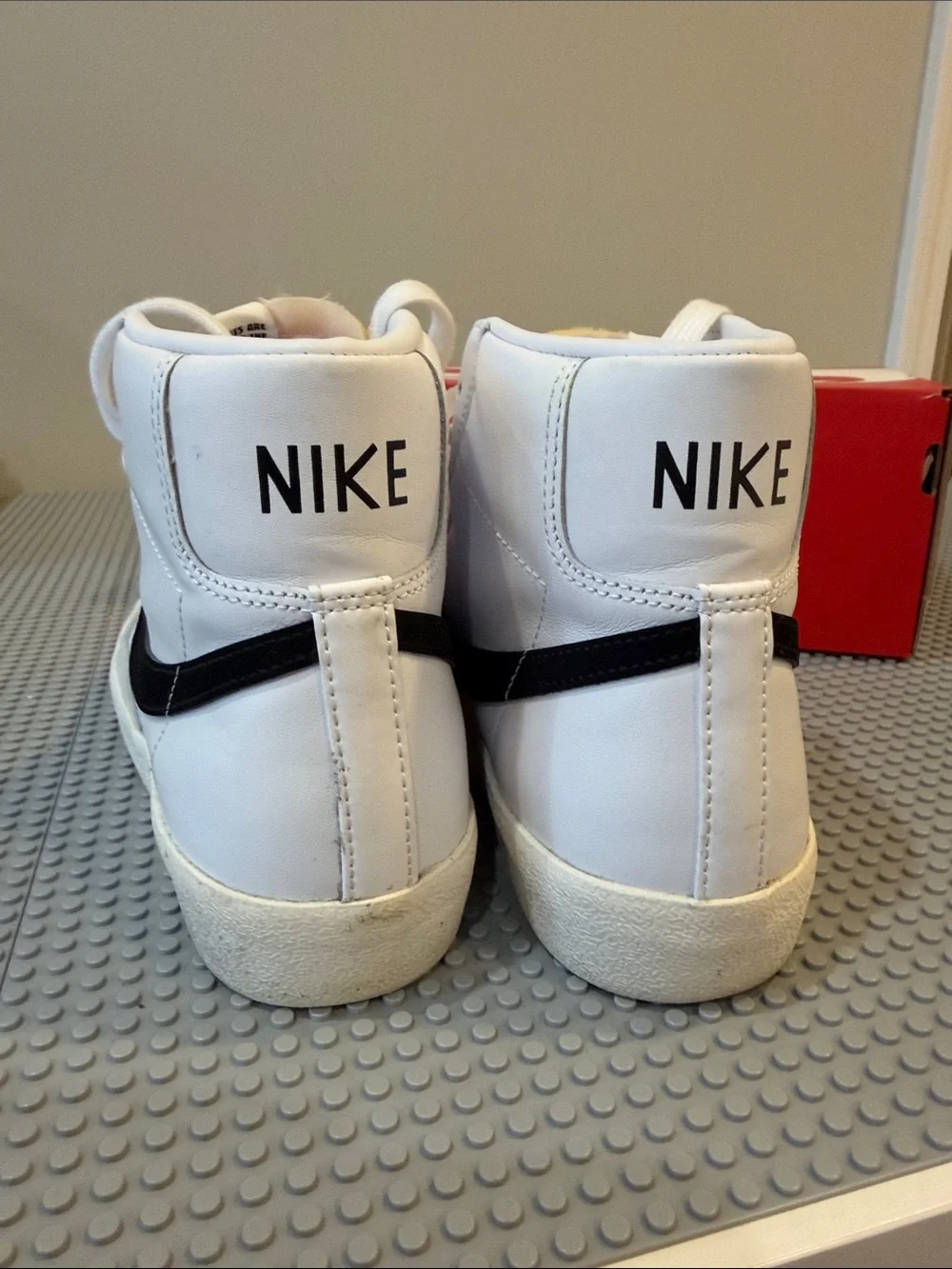 Nike White High-Top Sneakers with Black Swoosh